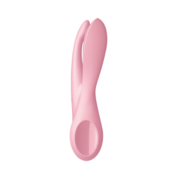 a pink vibrating device on a black background