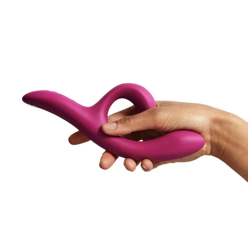 a person holding a pink vibrator n their hand