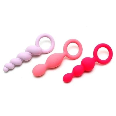 three pairs of pink, pink, and purple butt plug