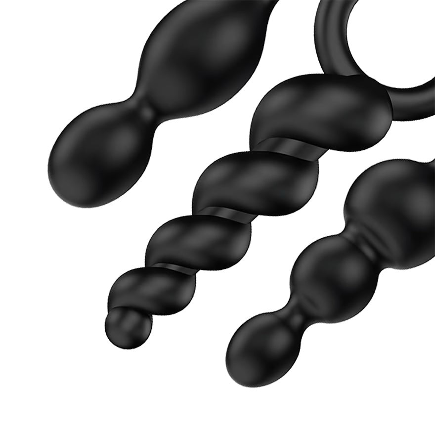 a pair of black beads hanging from a hook