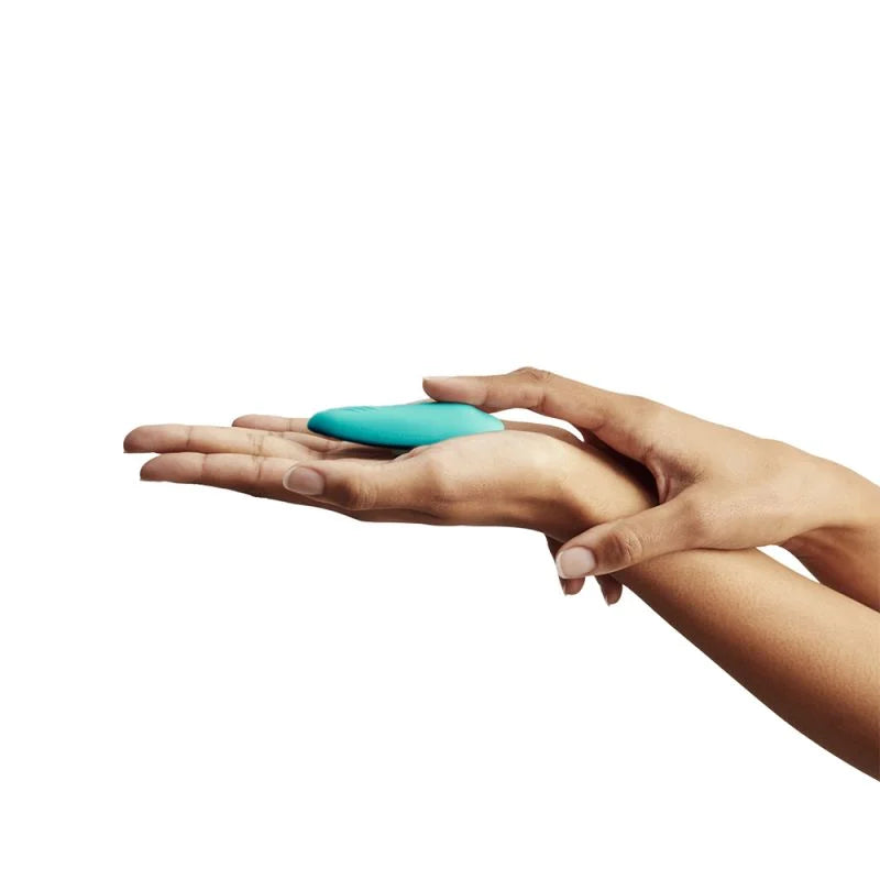 Moxie+ - Compact aqua Moxie+ clitoral vibrator held between hands with ouiboutique branding. - app, clitoridien, couple, vibrateur