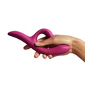a person holding a pink vibrator n their hand