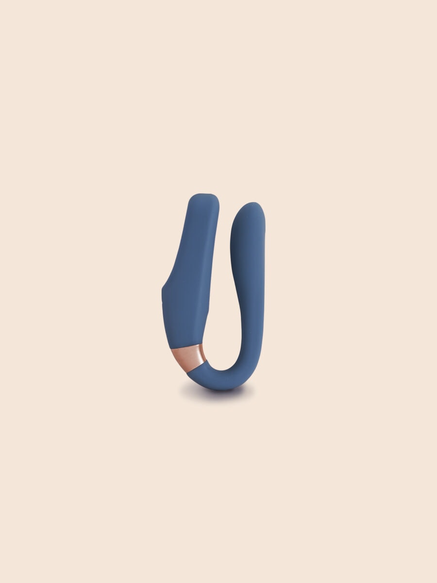 The Wearable - Compact navy blue wearable device held between hands with transparent tip, ouiboutique style.