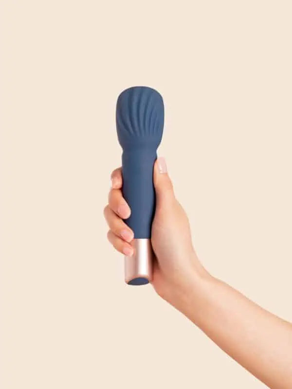 The Wand - Deia - Blue textured wand vibrator standing on a blue base next to navy Deia branded box with gold lettering ouiboutique. - clitoridien, couple, massage, vibrateur