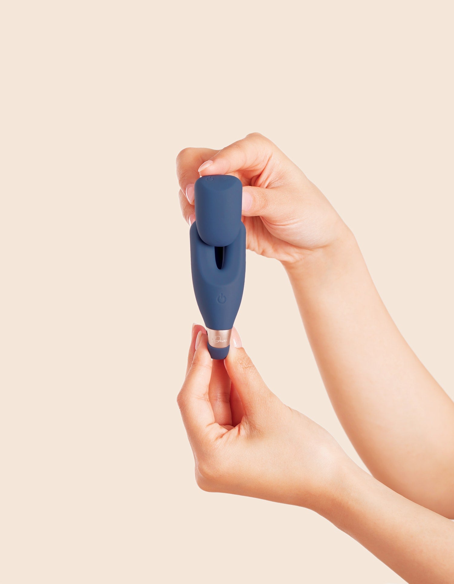 The Wearable - Compact navy blue wearable device held between hands with transparent tip, ouiboutique style.